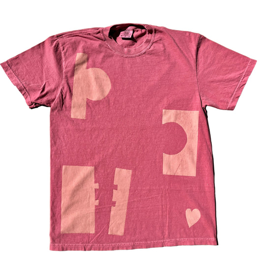 Pink t-shirt with abstract designs on a beige background